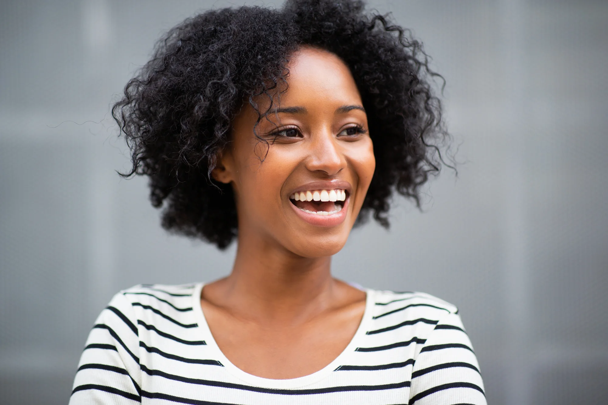 happy woman after going to a dentist on Park Road in Charlotte, NC