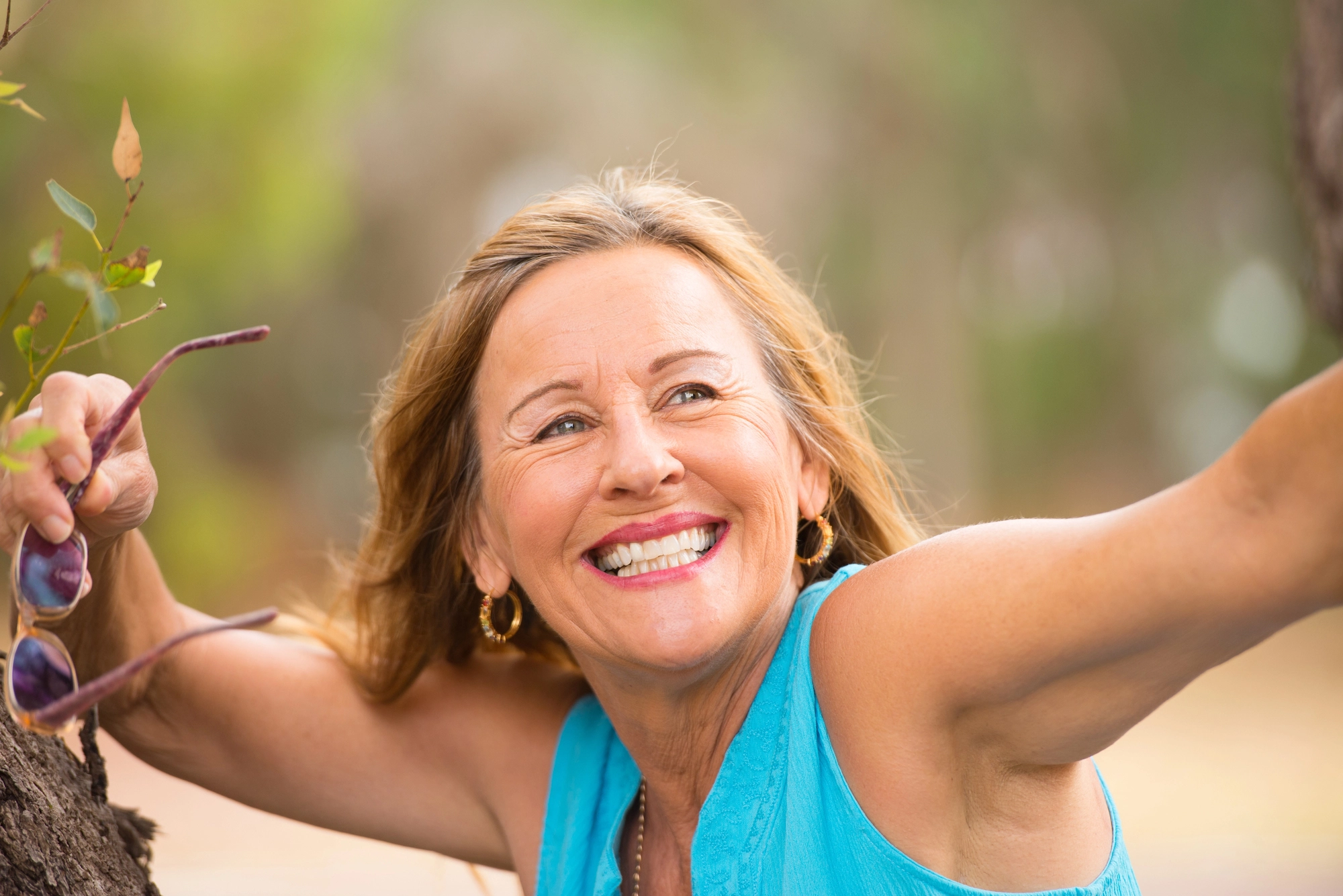 happy woman after getting dental crowns in Charlotte, NC