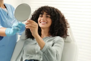 woman looking at herself after cosmetic dentistry in Uptown Charlotte (1)
