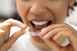 woman putting on Invisalign in Uptown Charlotte