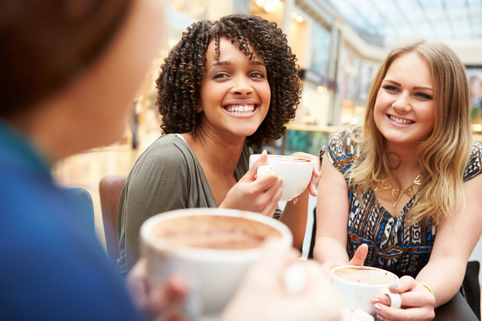 women smiling at a café after getting veneers in South Charlotte