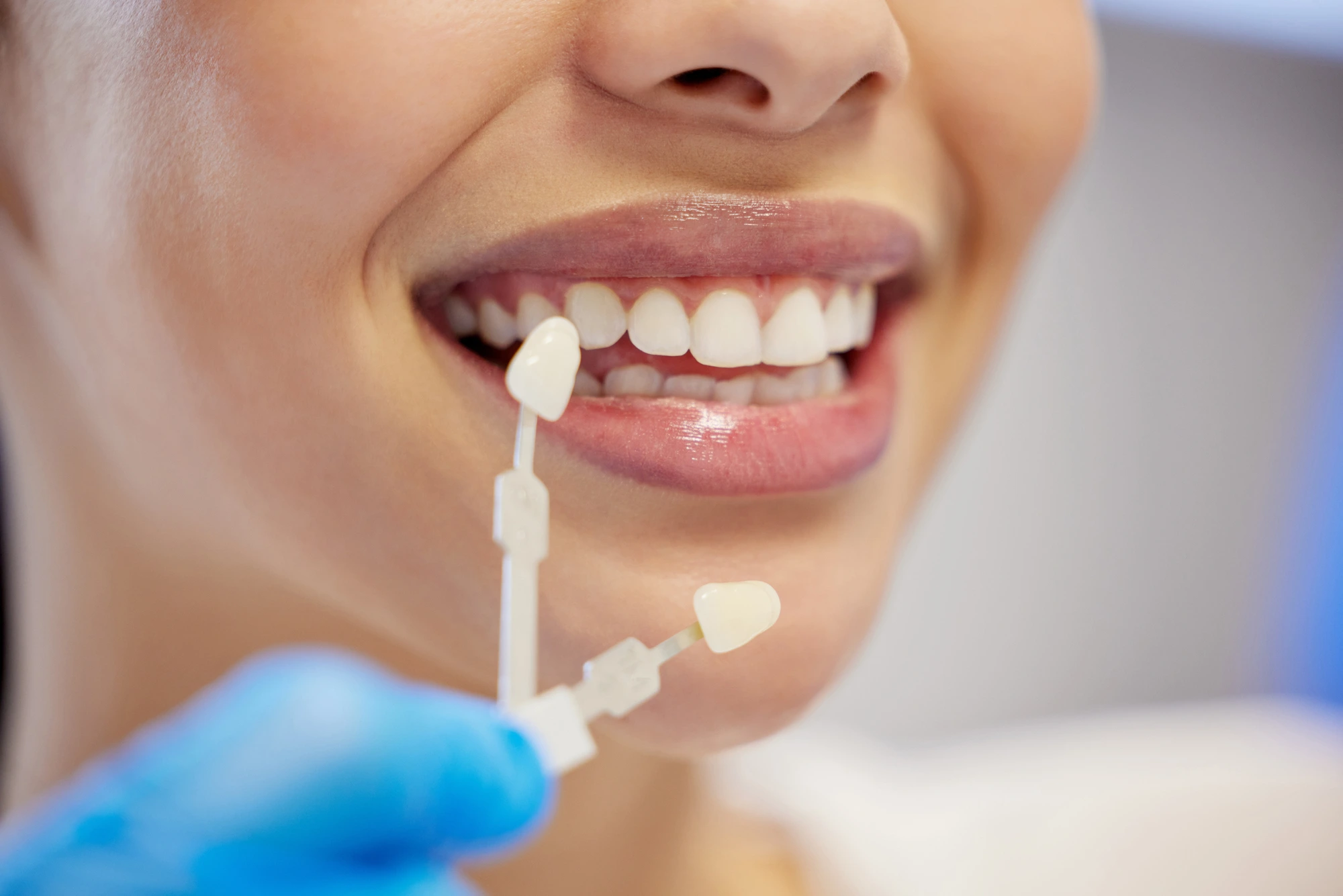woman trying on veneers with cosmetic dentists in Park Road, NC