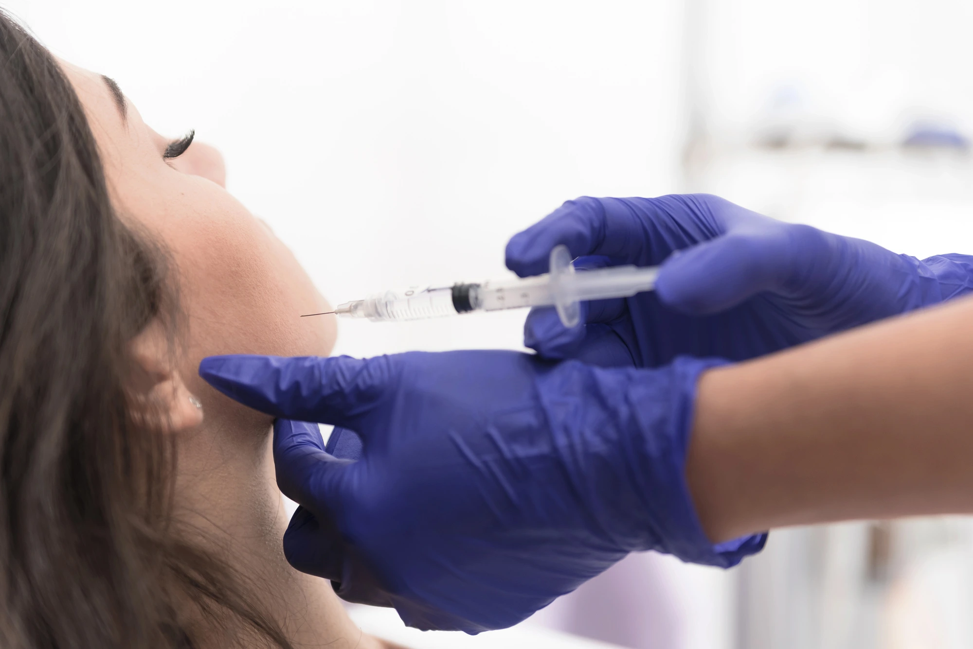 dentist applying Botox for TMJ in Charlotte